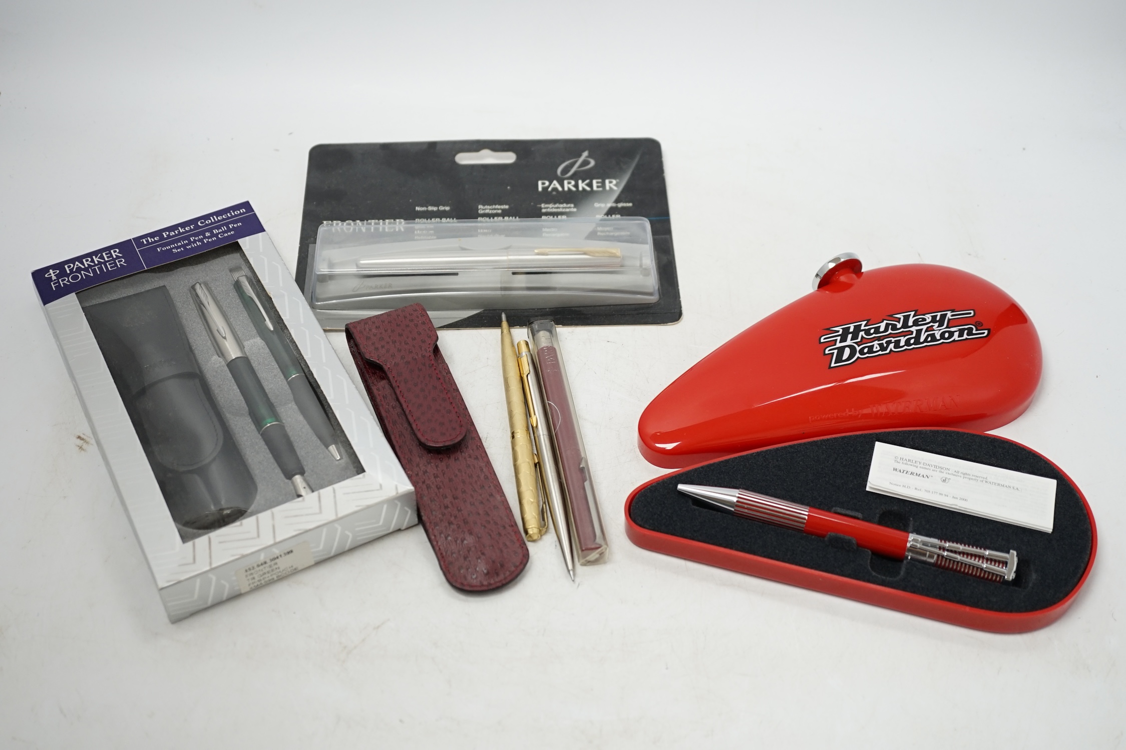 A Parker Duofold, a lapis lazuli fountain and ballpoint pen and a faux greenstone fountain pen, a Waterman Harley Davidson ballpoint pen, and nine other Parker / Waterman pens and pencils. Condition - fair